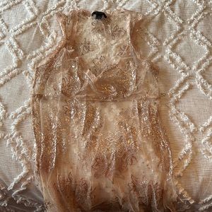 Delicate sheer top. Nice to wear over a camisole/tank. From express.